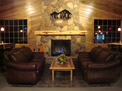 Waiting area with a fireplace and couches.